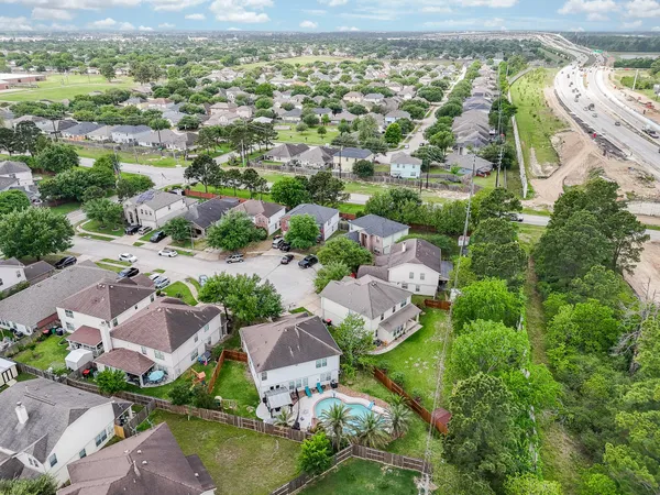 an aerial view of residential houses with outdoor space
