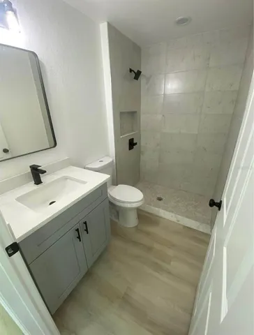 a bathroom with a double vanity sink toilet and shower