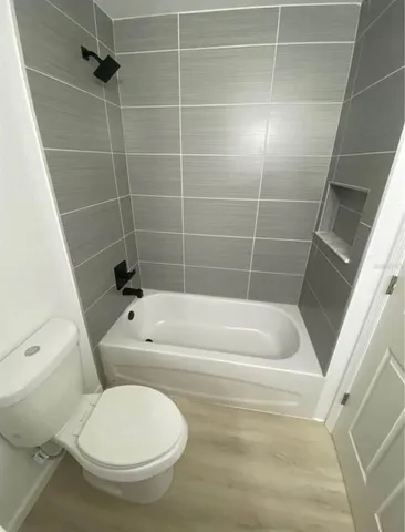 a bathroom with a toilet and a bathtub
