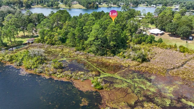 an aerial view of a house with a lake view