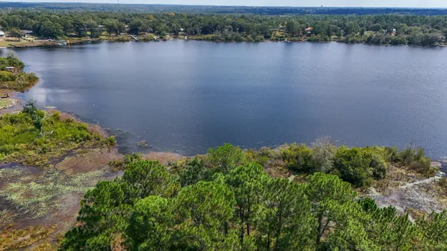 an aerial view of a house with a lake view