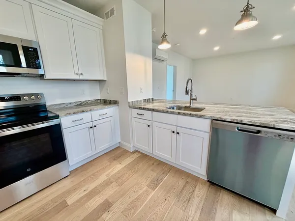 a kitchen with a sink stove and cabinets