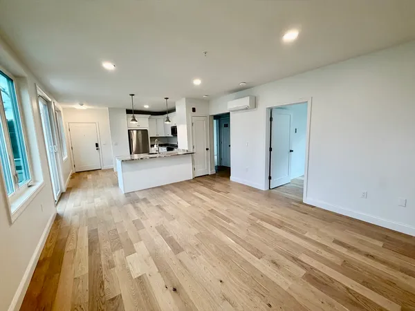a view of a kitchen with a sink and wooden floor