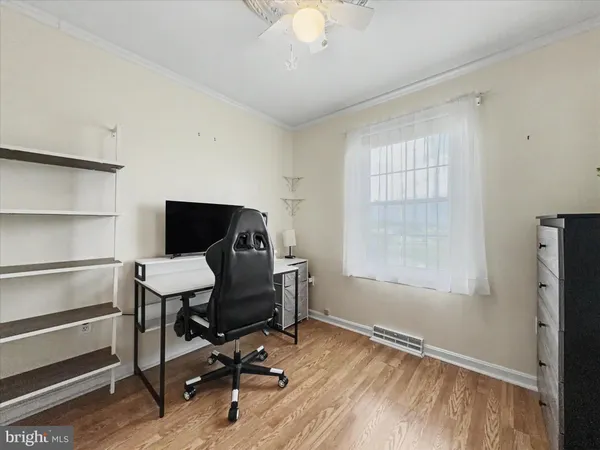 a view of a workspace with furniture and a window