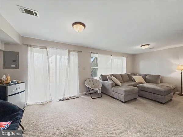 a living room with furniture a couch and dresser