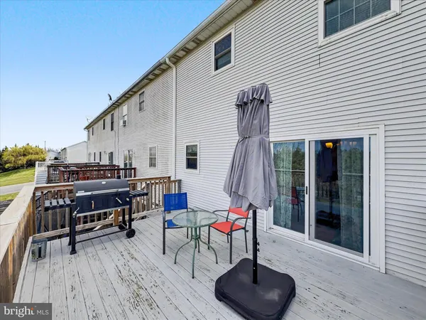 a backyard of a house with seating space and wooden floor