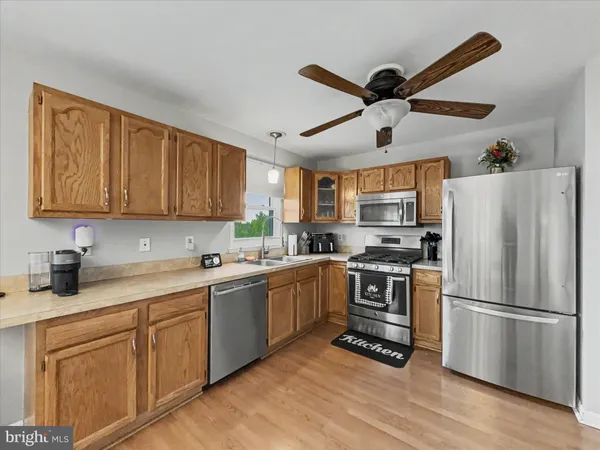 a kitchen with a sink stainless steel appliances and cabinets