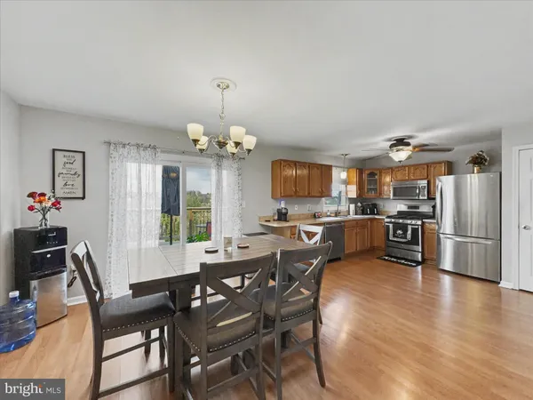 a view of a dining room with furniture and a chandelier