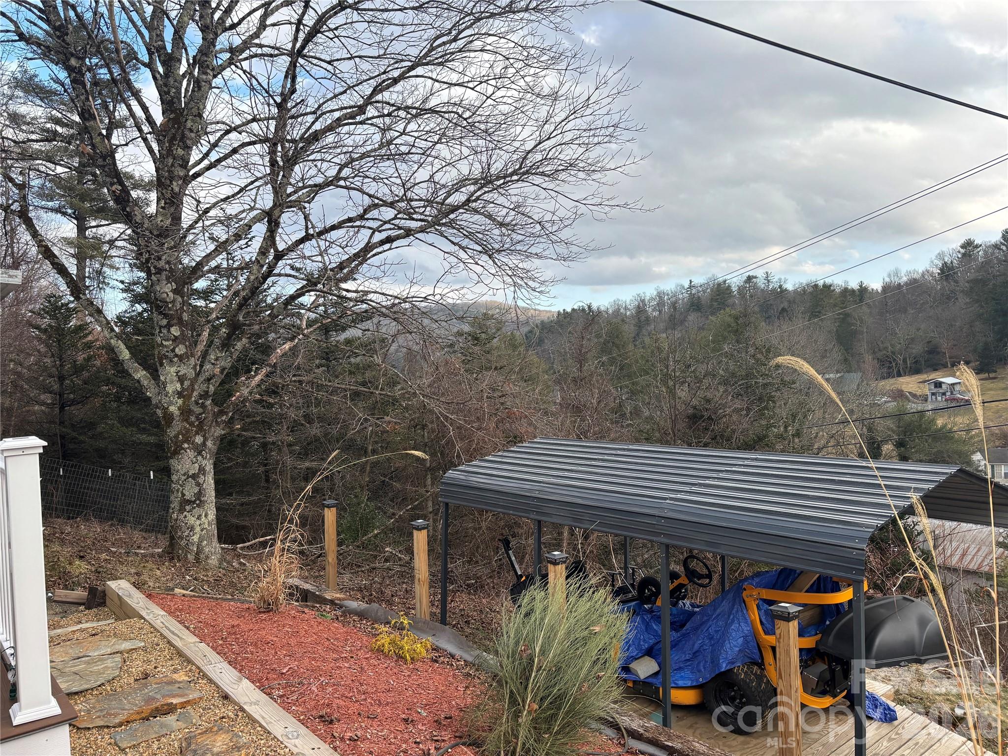 190 Benfield Road Crossnore, NC 28657 - Photo 11 of 36 a view of a roof deck with couches and wooden floor