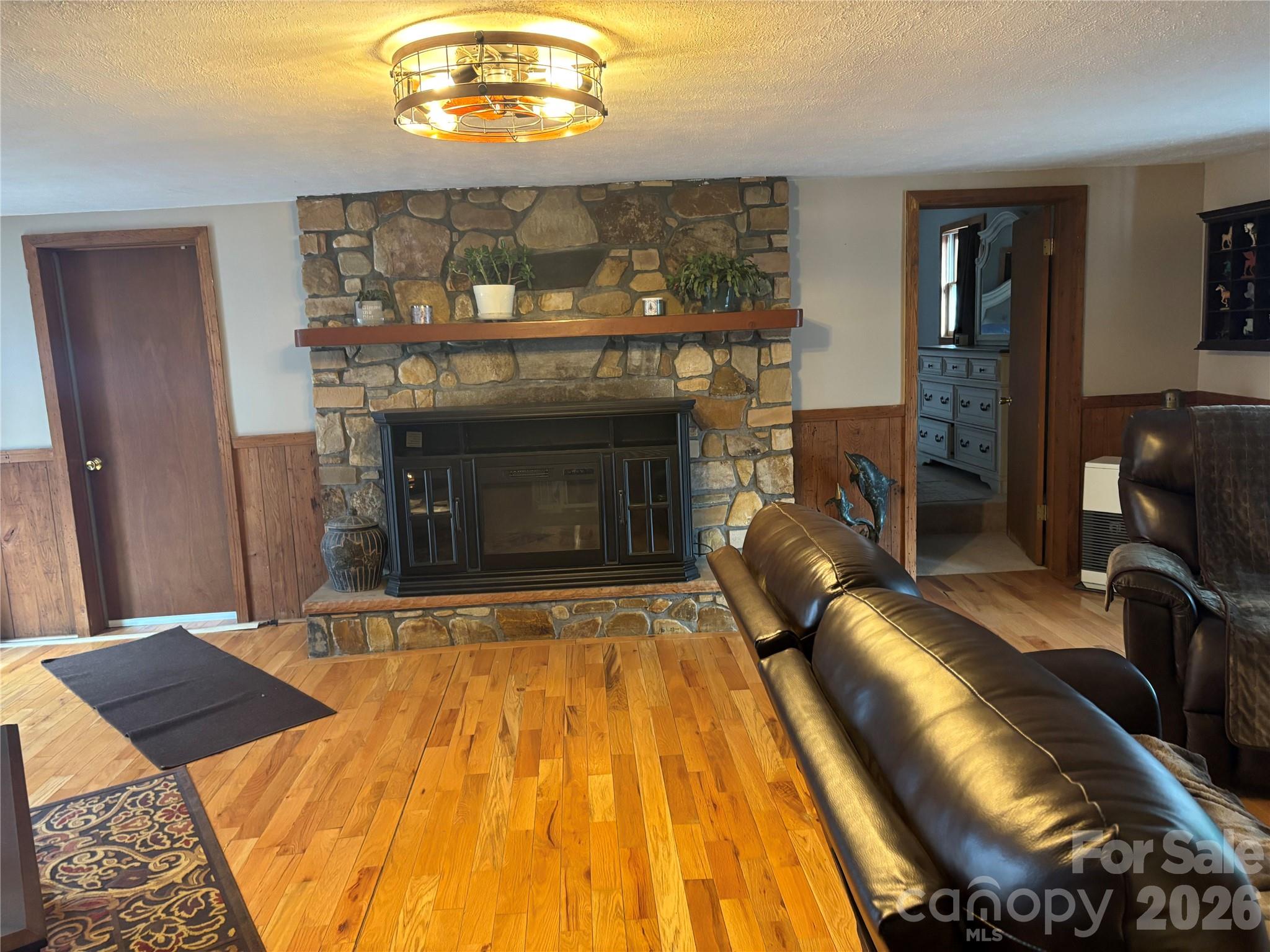 190 Benfield Road Crossnore, NC 28657 - Photo 22 of 36 a bedroom with a bed and a chandelier