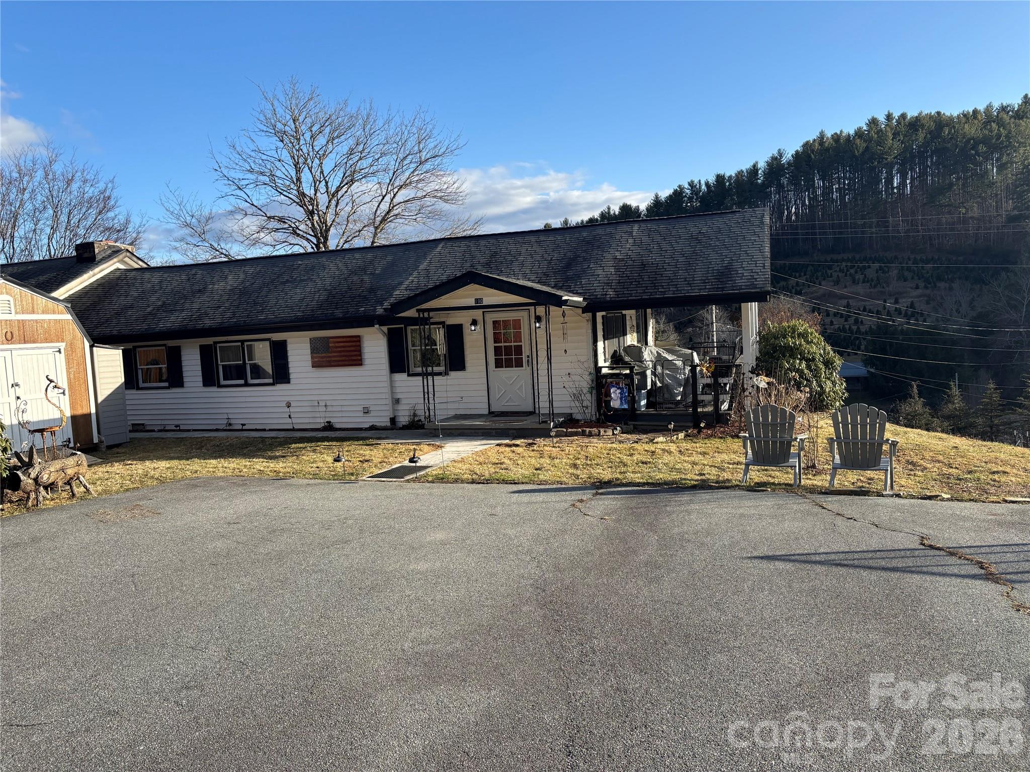 190 Benfield Road Crossnore, NC 28657 - Photo 27 of 36 a front view of a house with a yard and garage