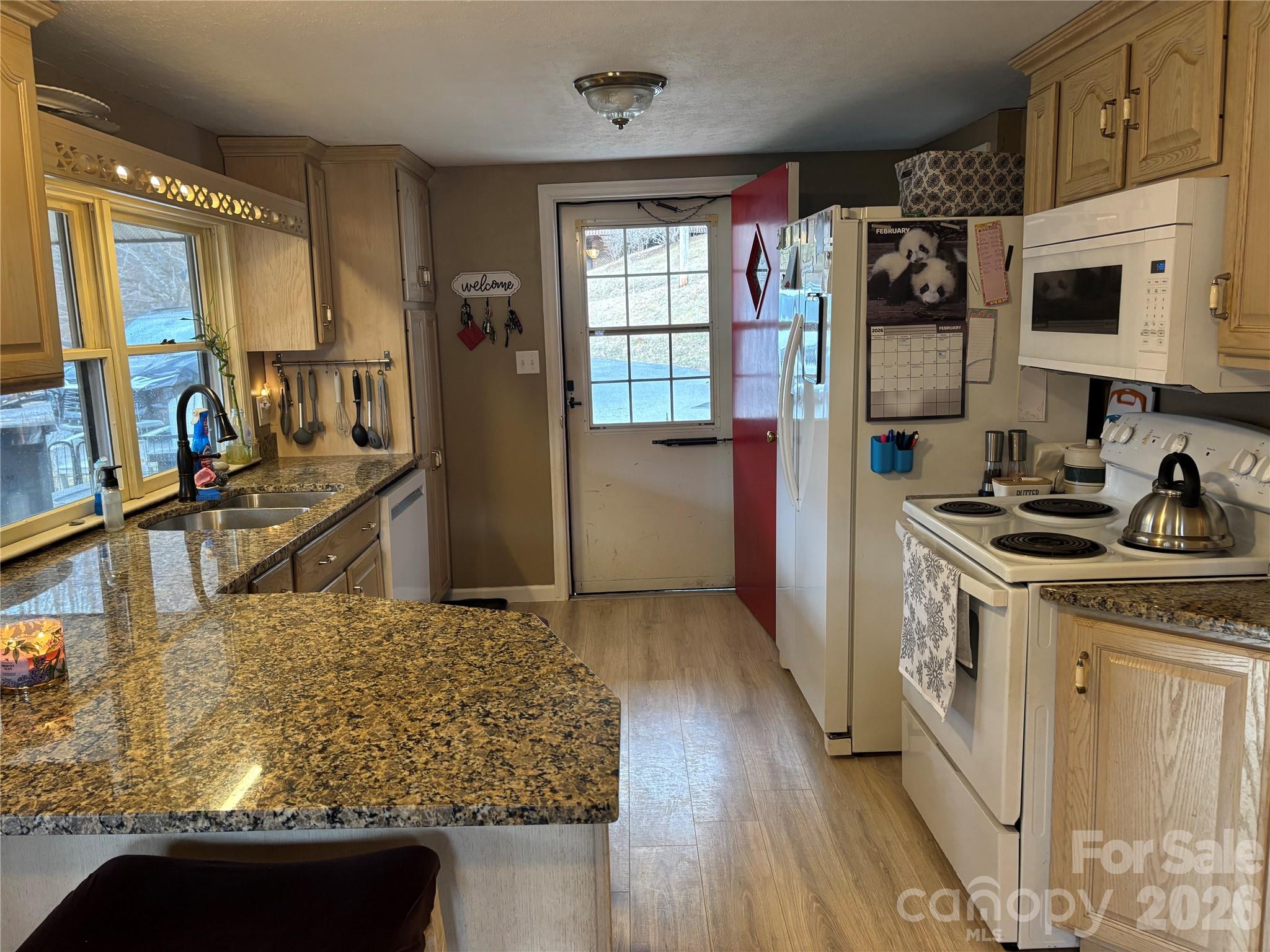 190 Benfield Road Crossnore, NC 28657 - Photo 6 of 36 a kitchen with stainless steel appliances granite countertop a sink stove and refrigerator