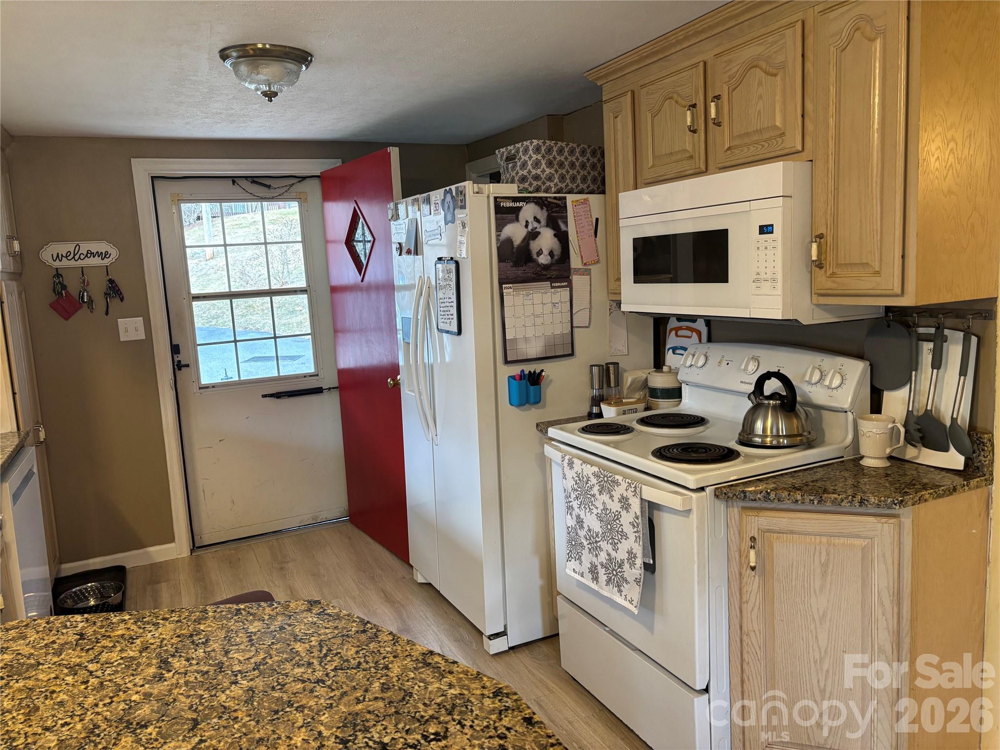 190 Benfield Road Crossnore, NC 28657 - Photo 7 of 36 a kitchen with stainless steel appliances granite countertop a stove a refrigerator and a sink