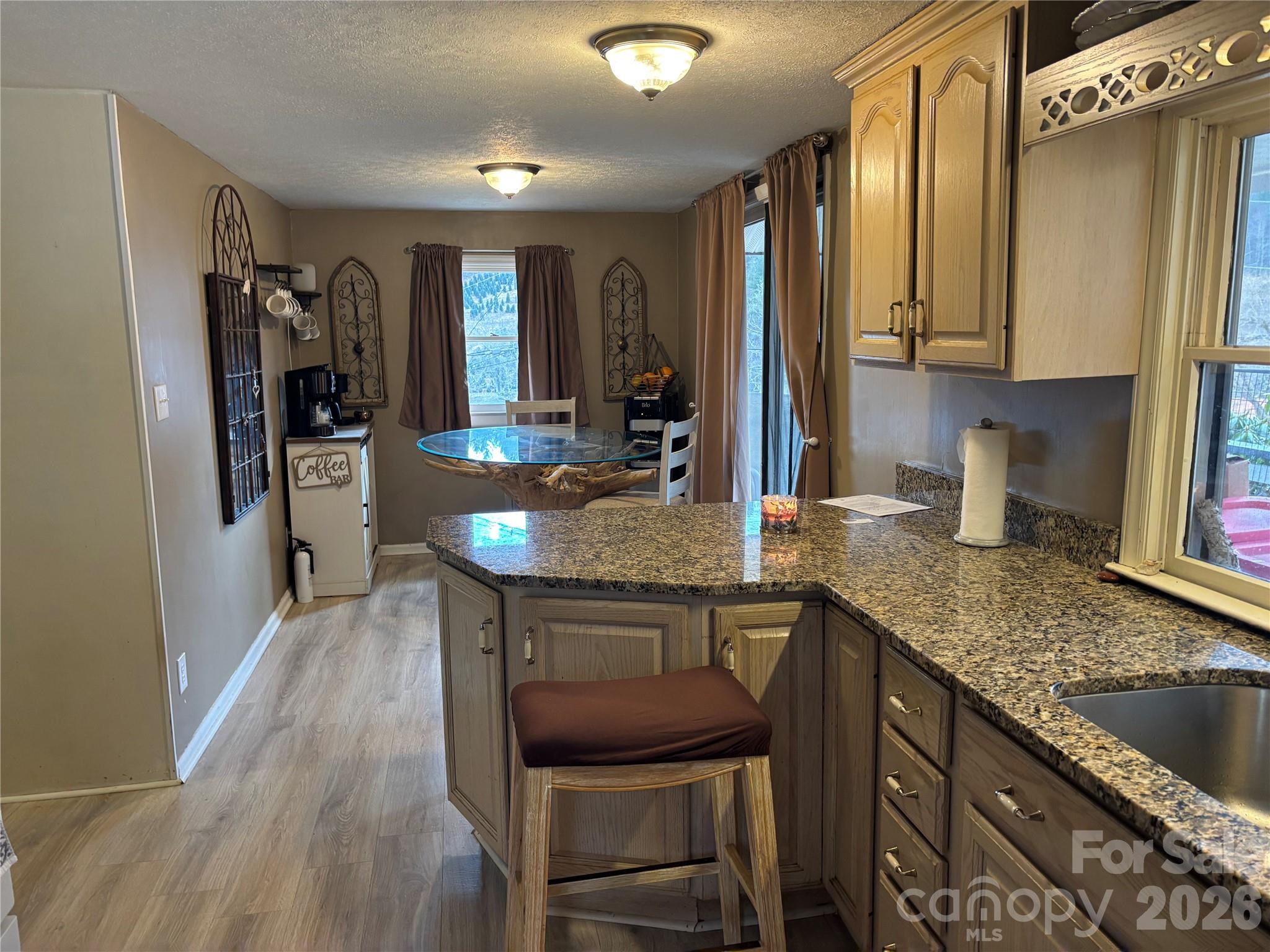 190 Benfield Road Crossnore, NC 28657 - Photo 9 of 36 a kitchen with a table chairs refrigerator and stove