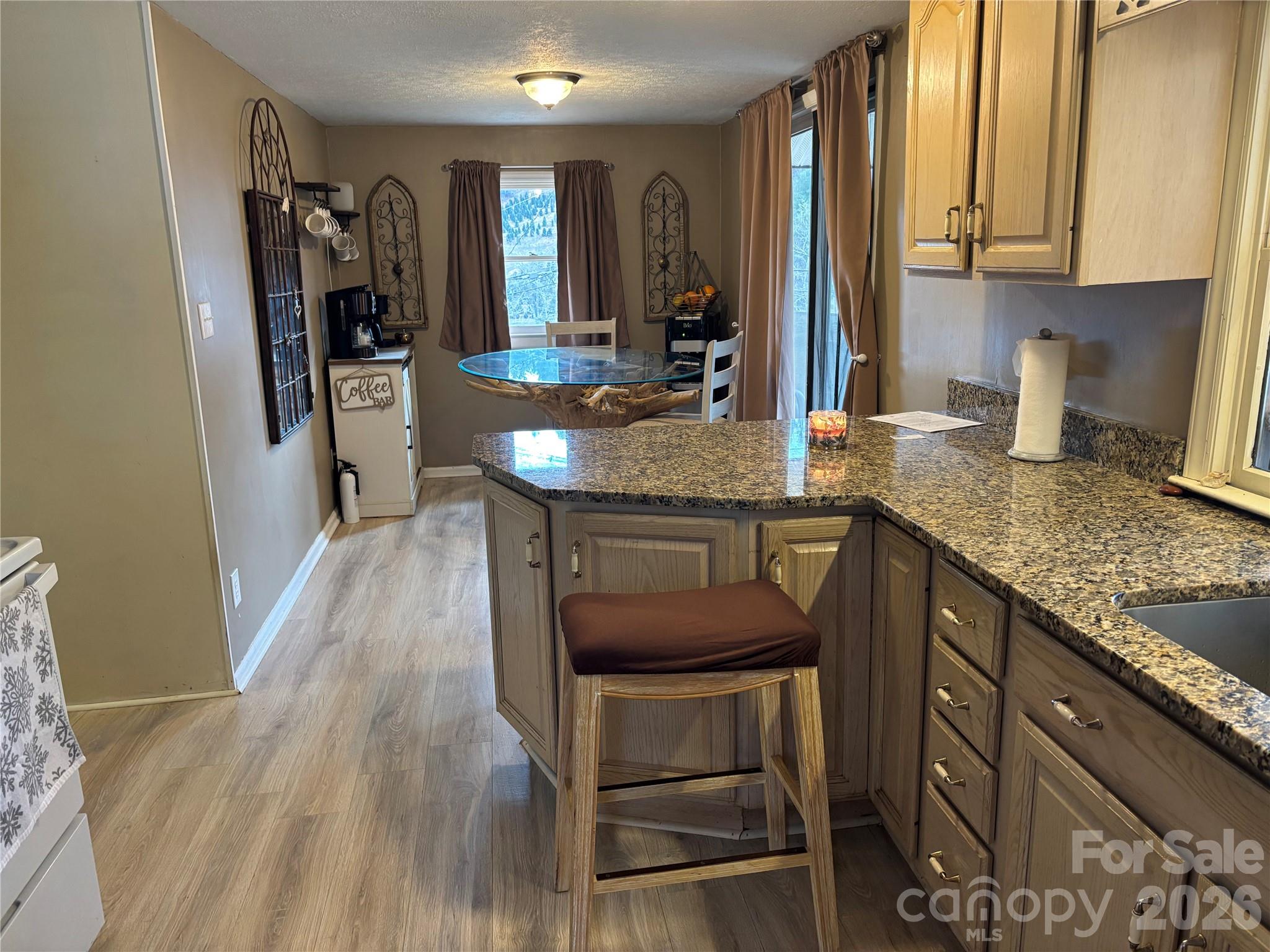 190 Benfield Road Crossnore, NC 28657 - Photo 10 of 36 a kitchen with granite countertop a sink appliances and cabinets