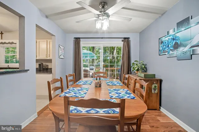 a kitchen with stainless steel appliances granite countertop a refrigerator a stove a sink and white cabinets