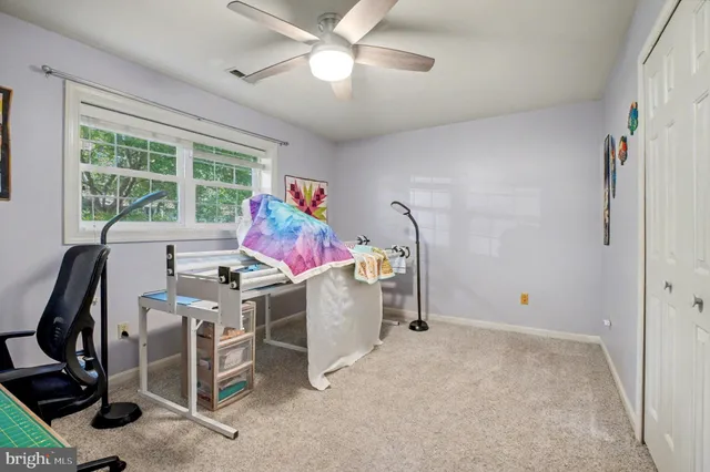 a view of a workspace with furniture and a window