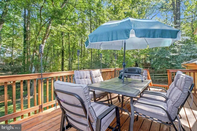 a view of a wooden deck with a yard