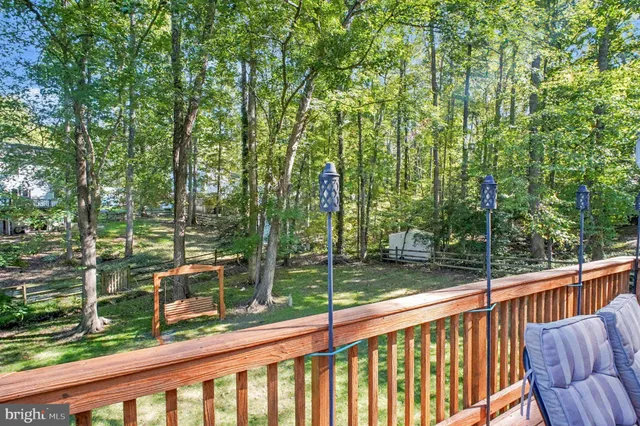 a view of a wooden deck next to a yard