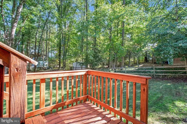 a view of balcony with wooden floor and fence