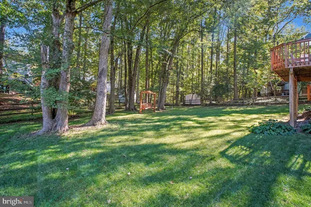 a view of a wooden deck with a yard
