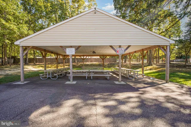 swimming pool view with a seating space