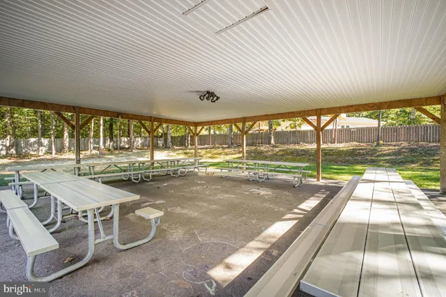 a picture of a wall with a white table and chairs