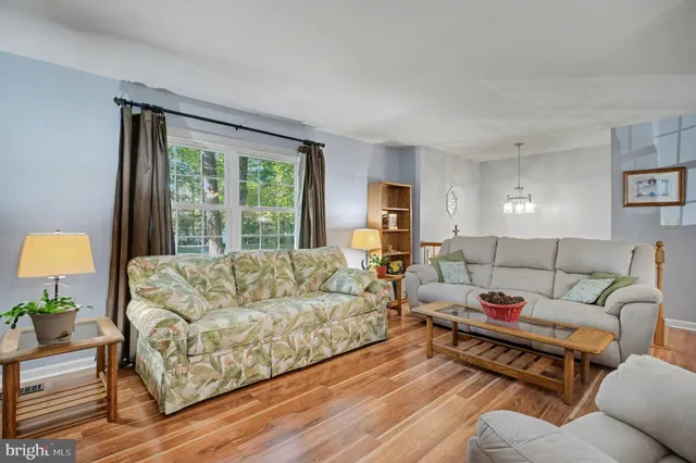 a bedroom with furniture and a wooden floor