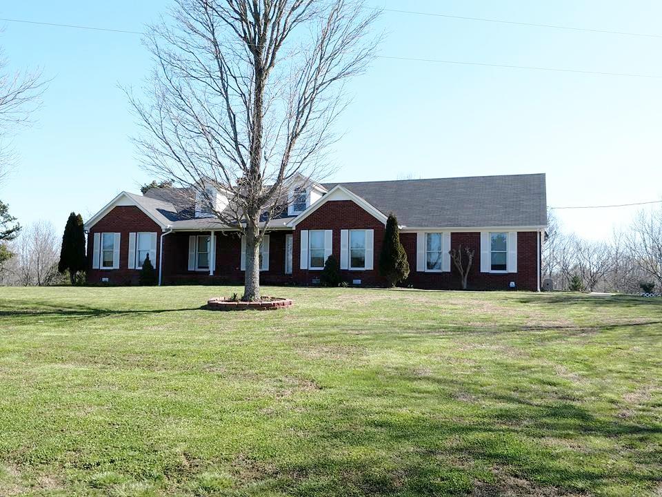 1015 Oak Grove Road Goodspring, TN 38460 - Photo 3 of 30 a front view of a house with a garden