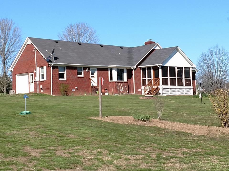 1015 Oak Grove Road Goodspring, TN 38460 - Photo 7 of 30 a front view of a house with a garden