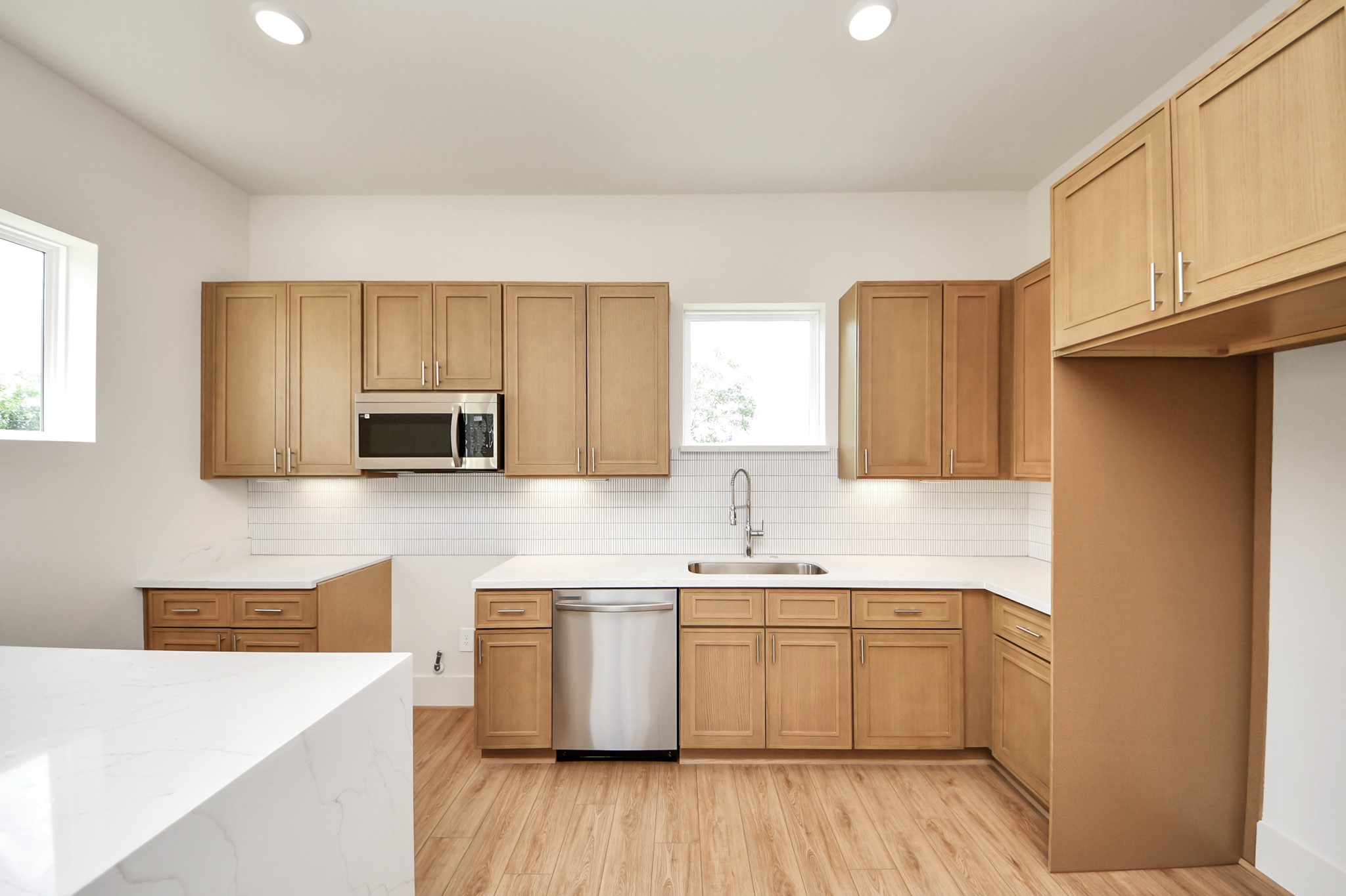 5903 Urban Pines Street Houston, TX 77091 - Photo 36 of 42 a kitchen with a sink a microwave and cabinets