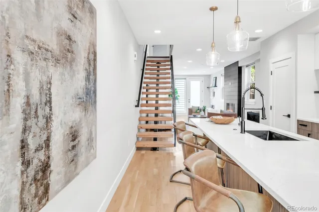 a large white kitchen with a large window