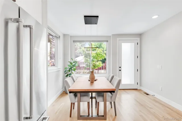 a view of a dining room with furniture window and wooden floor