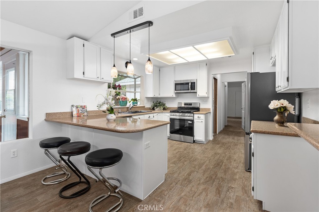 10526 Rainbrook Drive Fallbrook, CA 92028 - Photo 18 of 63 a kitchen with a sink a stove a refrigerator and chairs