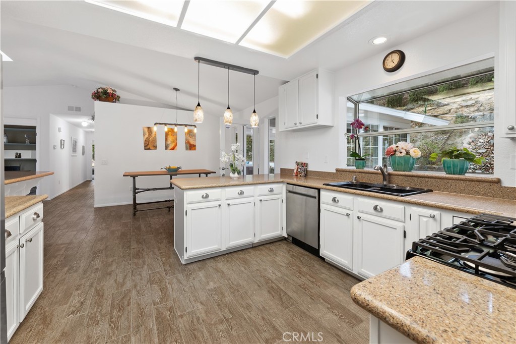 10526 Rainbrook Drive Fallbrook, CA 92028 - Photo 19 of 63 a kitchen with a sink stove and white cabinets