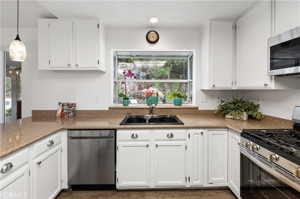 10526 Rainbrook Drive Fallbrook, CA 92028 - Photo 20 of 63 a kitchen with stainless steel appliances granite countertop a sink and a stove