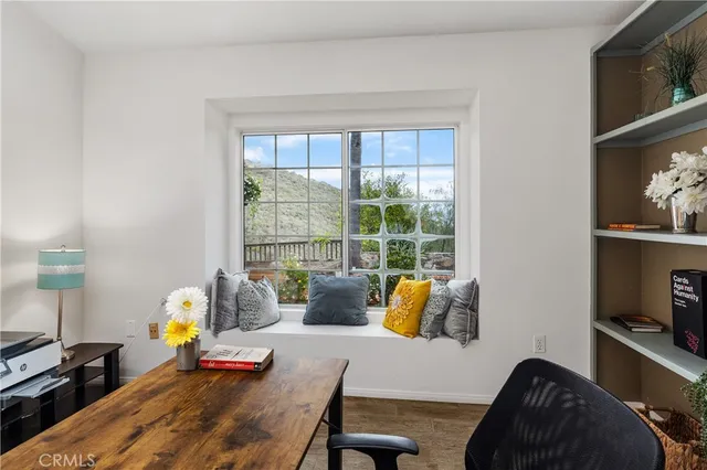 a bedroom with furniture and a large window