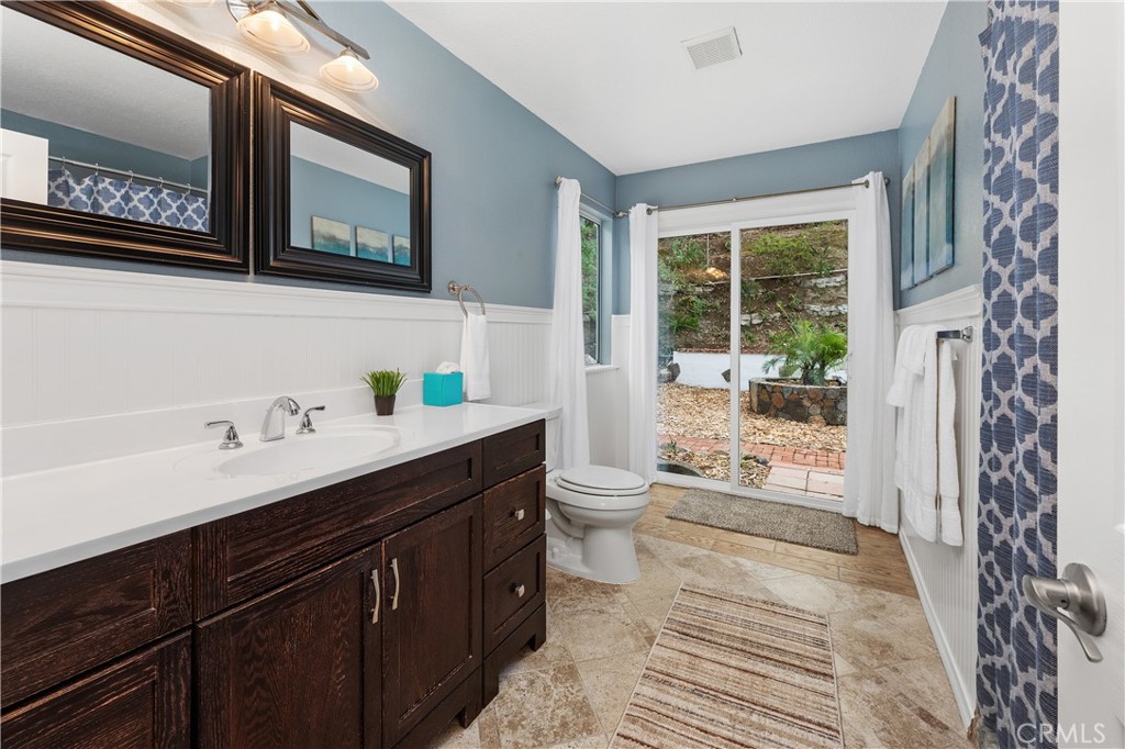 10526 Rainbrook Drive Fallbrook, CA 92028 - Photo 26 of 63 a spacious bathroom with a sink a toilet a mirror and shower