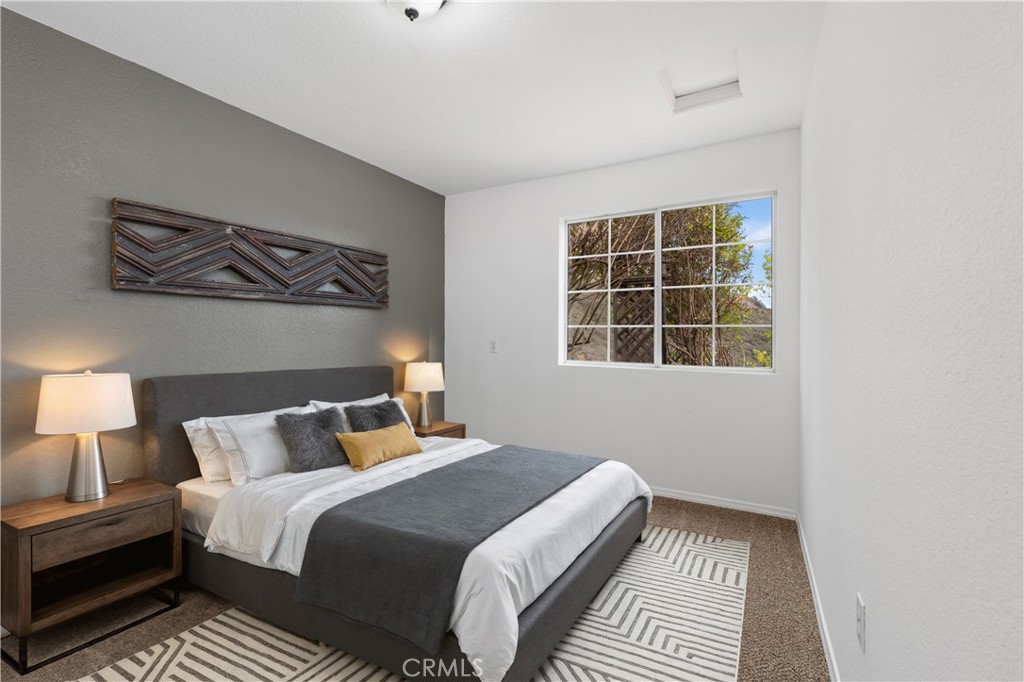 10526 Rainbrook Drive Fallbrook, CA 92028 - Photo 30 of 63 a bedroom with a bed and wooden floor