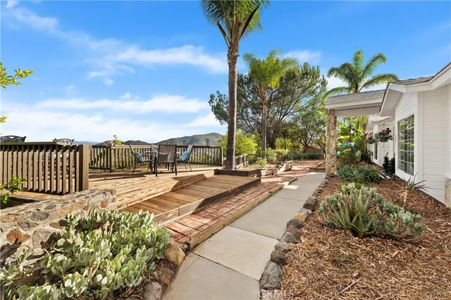 a view of a house with backyard and sitting area