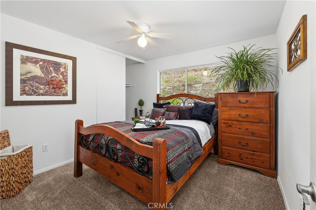 10526 Rainbrook Drive Fallbrook, CA 92028 - Photo 44 of 63 a bedroom with a bed and a chandelier