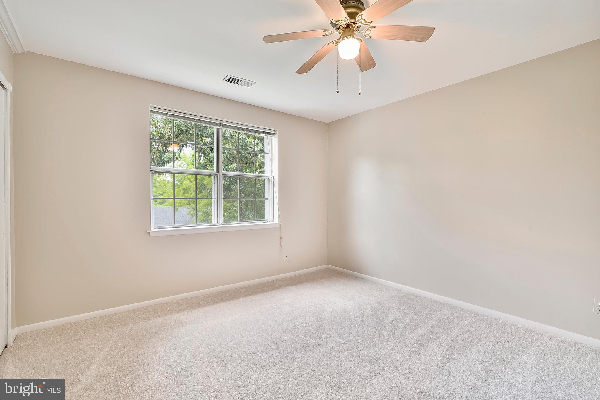 4615 28th Road South, Unit B Arlington, VA 22206 - Photo 11 of 24 an empty room with a window and a fan