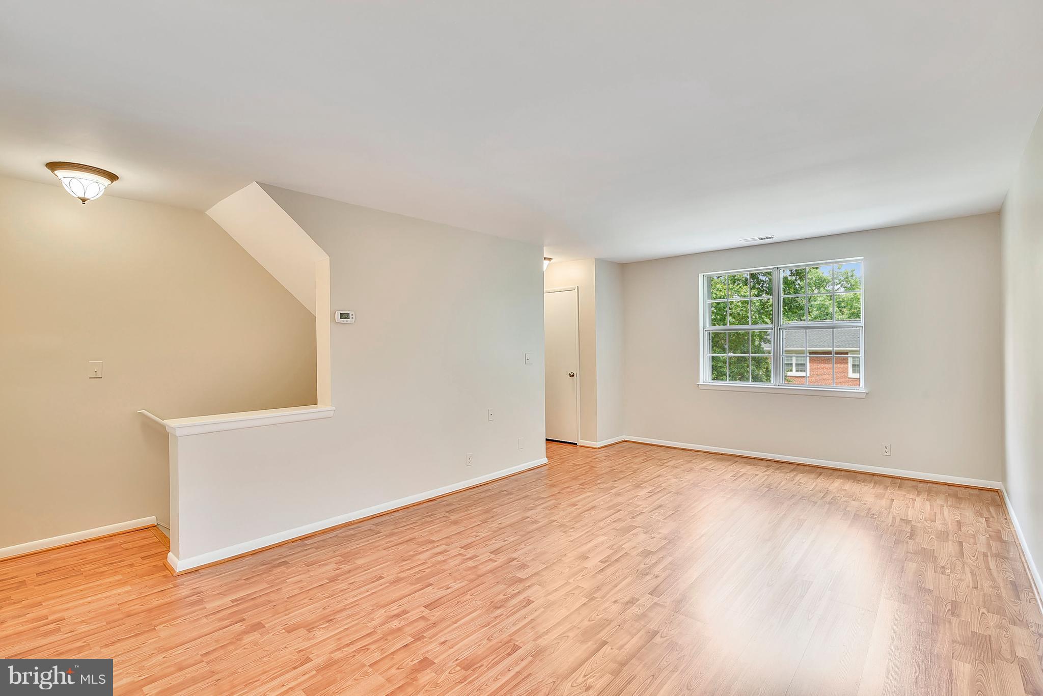 4615 28th Road South, Unit B Arlington, VA 22206 - Photo 3 of 24 an empty room with wooden floor and windows