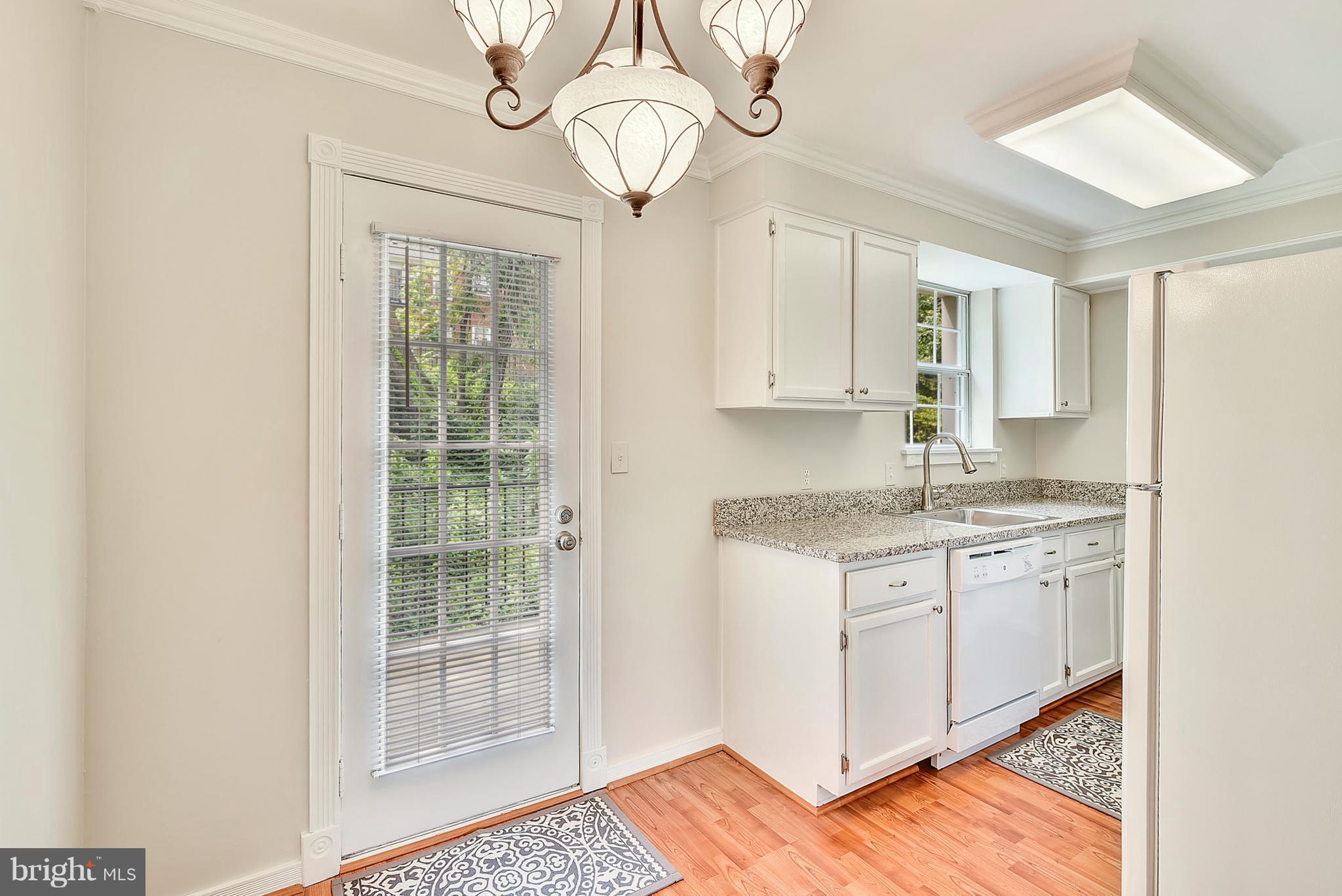 4615 28th Road South, Unit B Arlington, VA 22206 - Photo 5 of 24 a kitchen with granite countertop cabinets stainless steel appliances a sink and a window