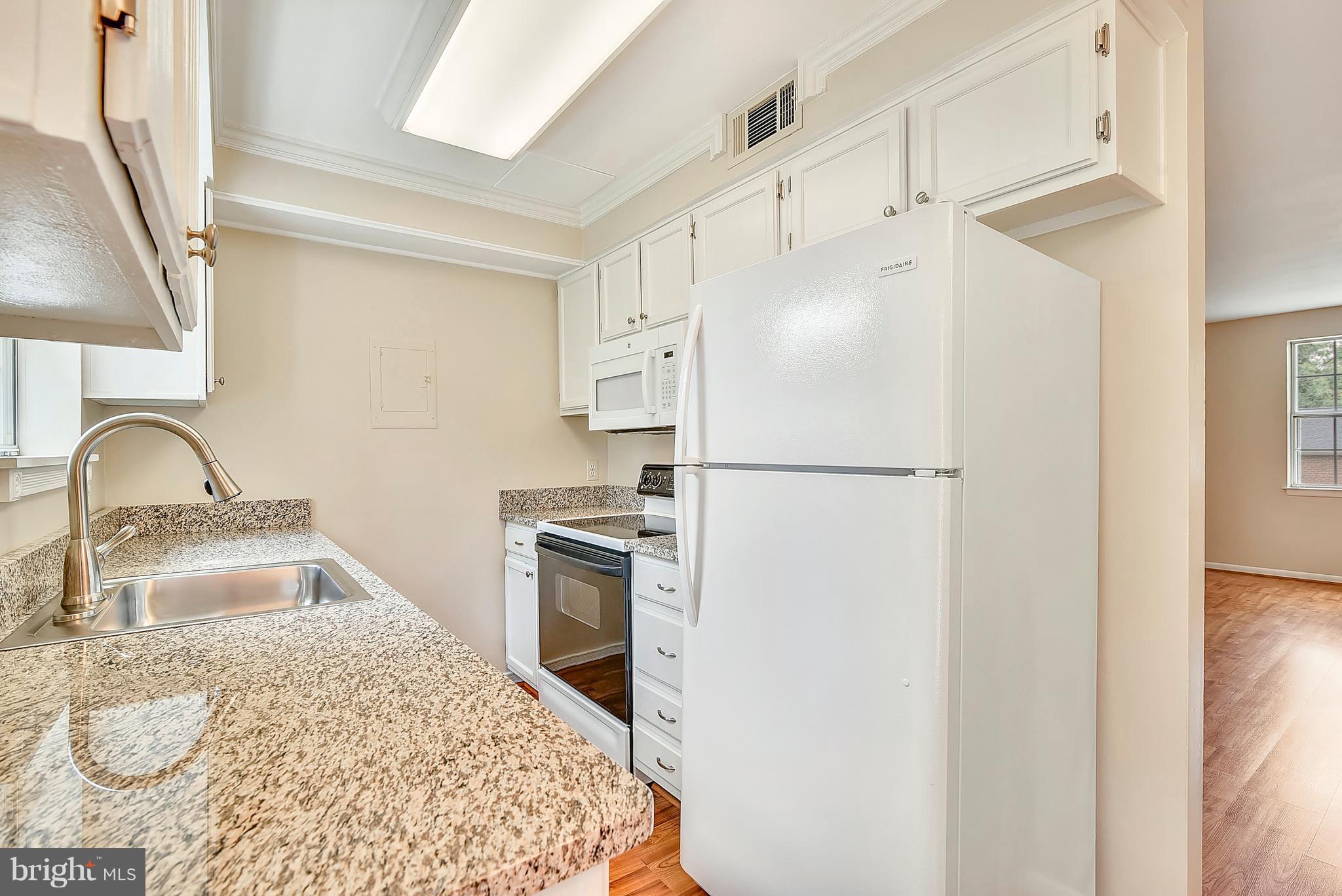 4615 28th Road South, Unit B Arlington, VA 22206 - Photo 6 of 24 a kitchen with granite countertop a refrigerator sink stove and oven