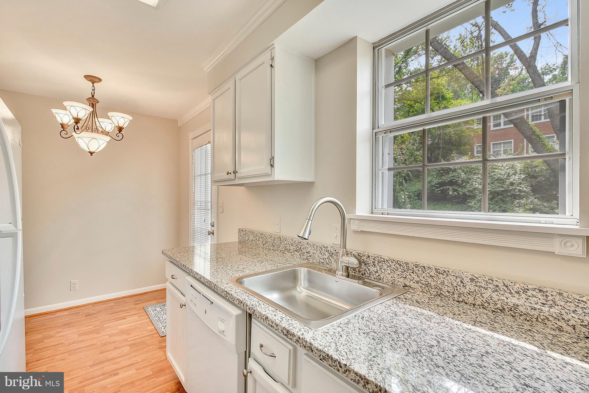 4615 28th Road South, Unit B Arlington, VA 22206 - Photo 8 of 24 a kitchen with a sink granite counter tops and a window