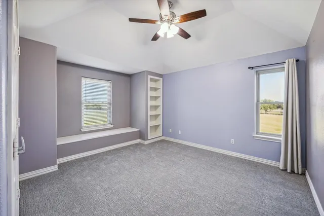 an empty room with windows and closet