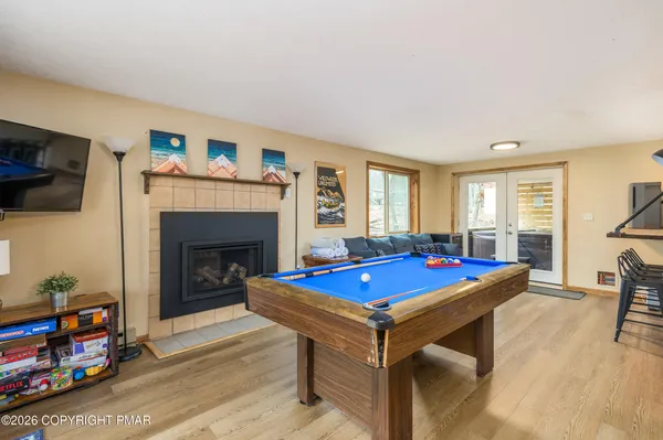 a living room with furniture a flat screen tv and a fireplace