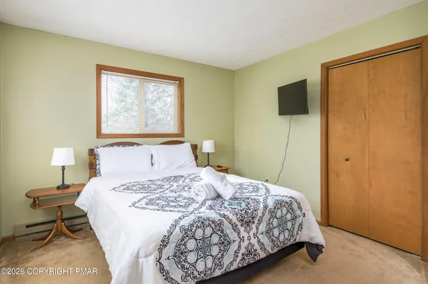 a bedroom with a bed and a lamp on table