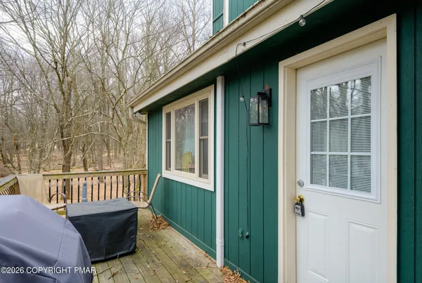 a view of a house with backyard and deck